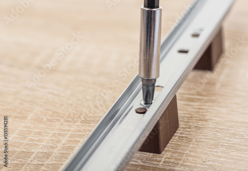Close-up of screwdriver and screw