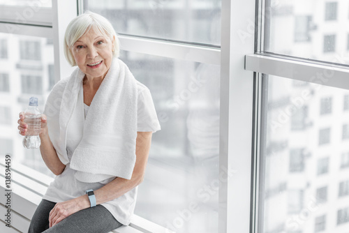 Healthy mature lady drinking water after exercising Free Download Healthy mature lady drinking water after exercising - GFXLoad