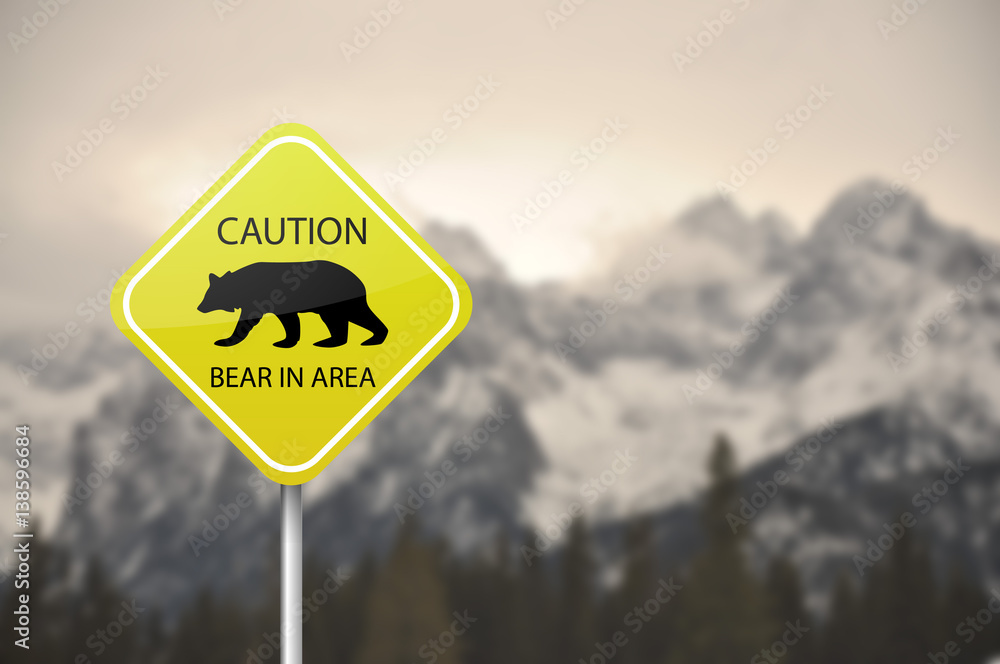 Yellow warning sign board - caution, bear in the area Yellow warning sign board - caution, bear in the area