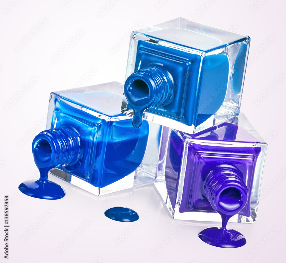 Bottles with spilled nail polish foto de Stock Adobe Stock