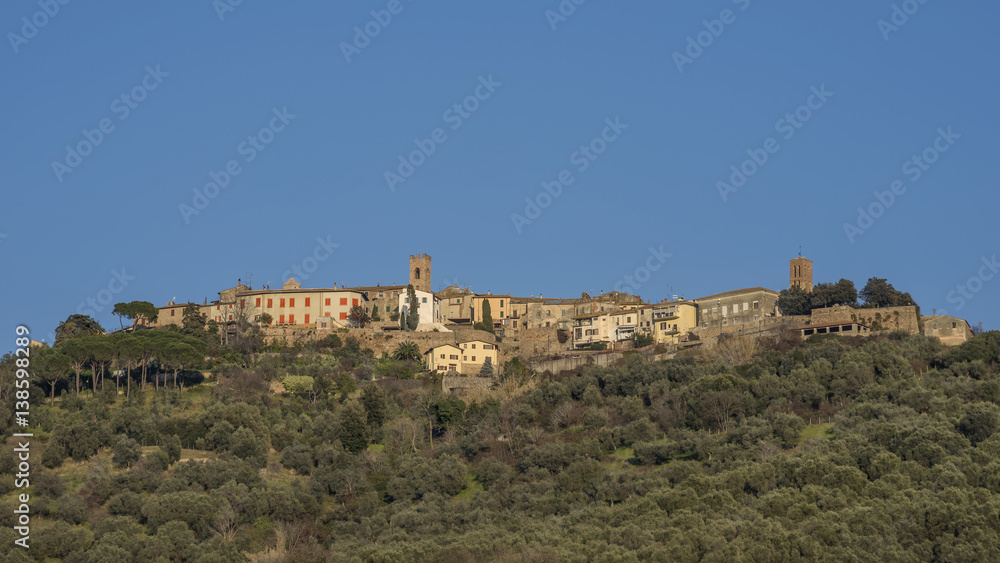 Beautiful panorama of the medieval village of Montepescali overlooking the whole hill and the forest below, Grosseto, Tuscany, Italy