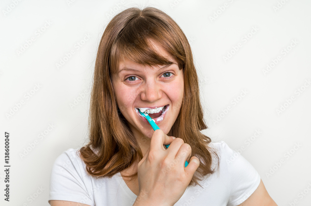 Woman brushing her teeth with toothbrush in the morning Woman brushing her teeth with toothbrush in the morning