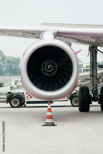 Vertical picture shows the engine of the aircraft, which stands at the airport
