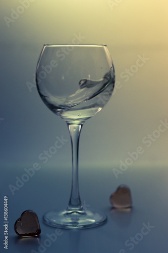 Splash water in a glass on a gray background
