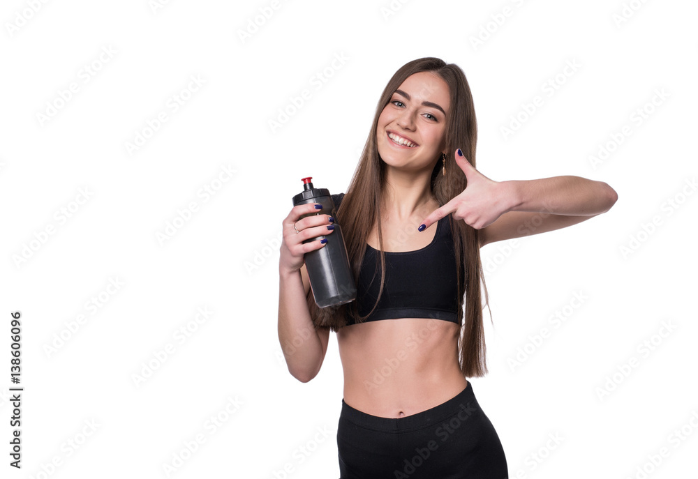 Portrait of smiling young sporty woman with a bottle of water posing in studio isolated on white background. Portrait of smiling young sporty woman with a bottle of water posing in studio isolated on white background.