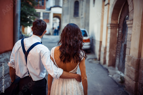 Young couple in love, hugging in the old part of town