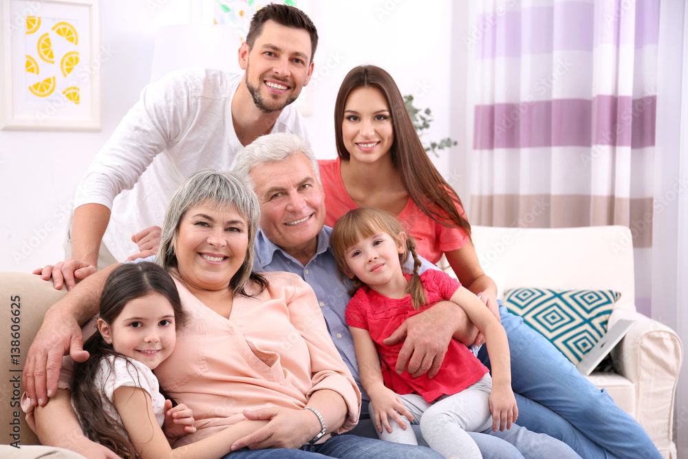 Happy family sitting on sofa in the room