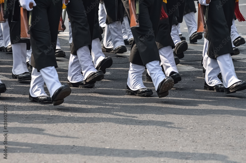 A group of military are walking with assault rifle