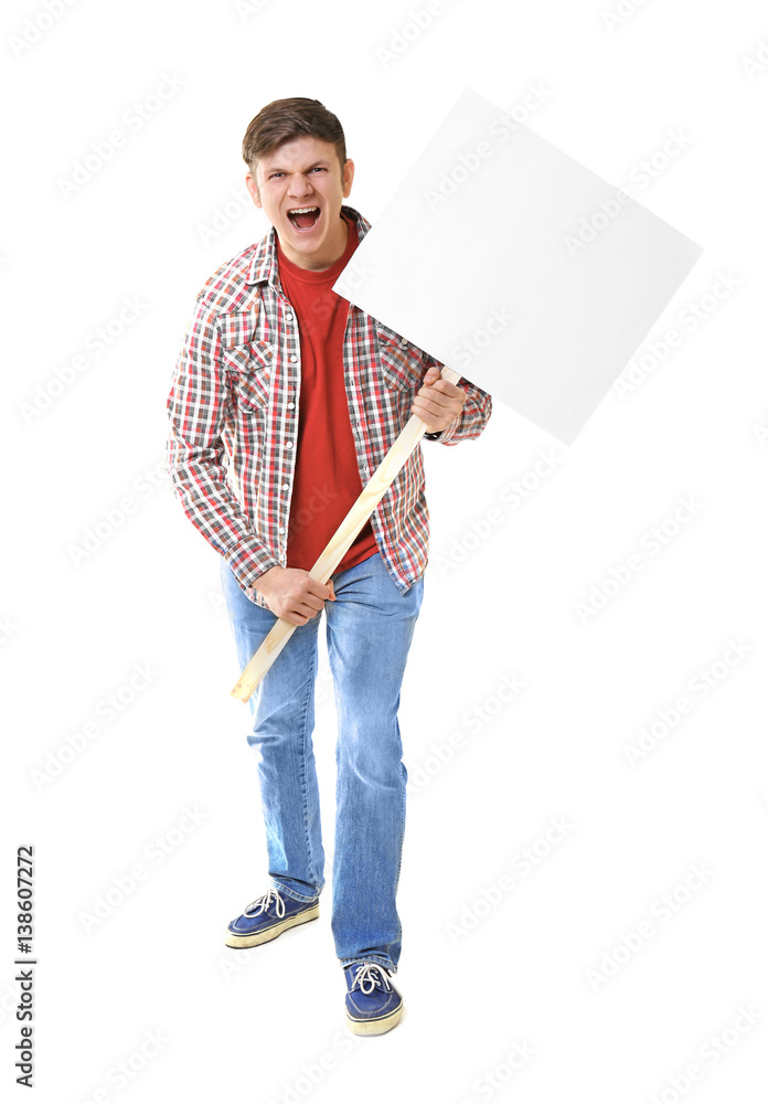 Protesting young man holding placard with space for text on light background Protesting young man holding placard with space for text on light background