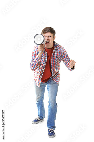 Protesting young man shouting into megaphone on light background © Africa Studio