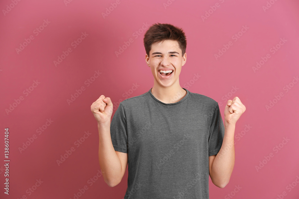 Happy teenage boy in casual clothes on color background Happy teenage boy in casual clothes on color background