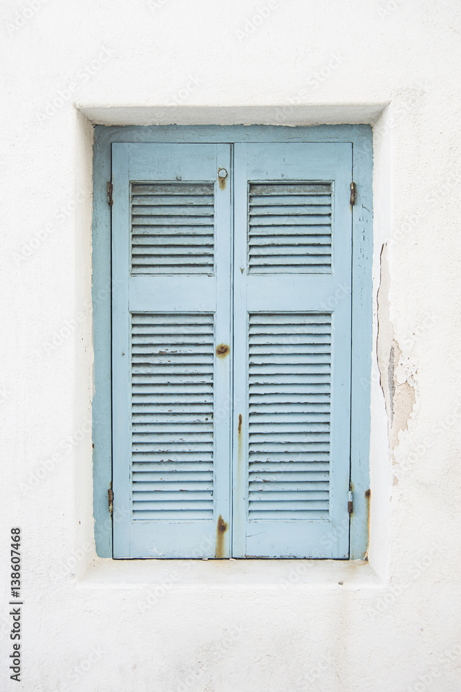 old light blue window shutters on whitewashed building, Mykonos Greece