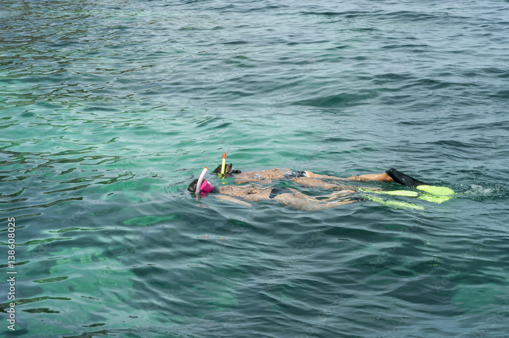 Snorkeling in clear blue water of tropical island