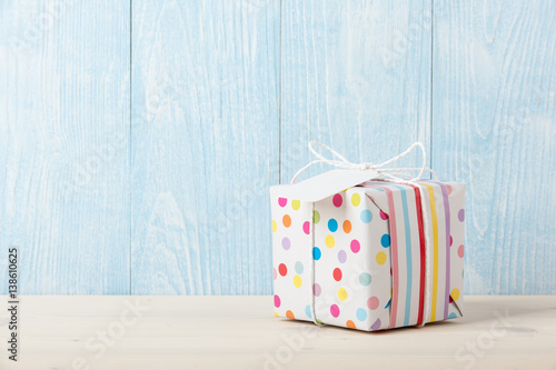 Polka dot gift box on wooden table
