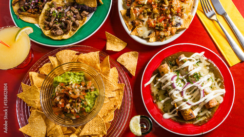 Mixed mexican food: Guacamole, nachos, fajita, meat tacos. Top view. Tex-mex cuisine. Assorted appetizers. Cuisine of Mexico photo