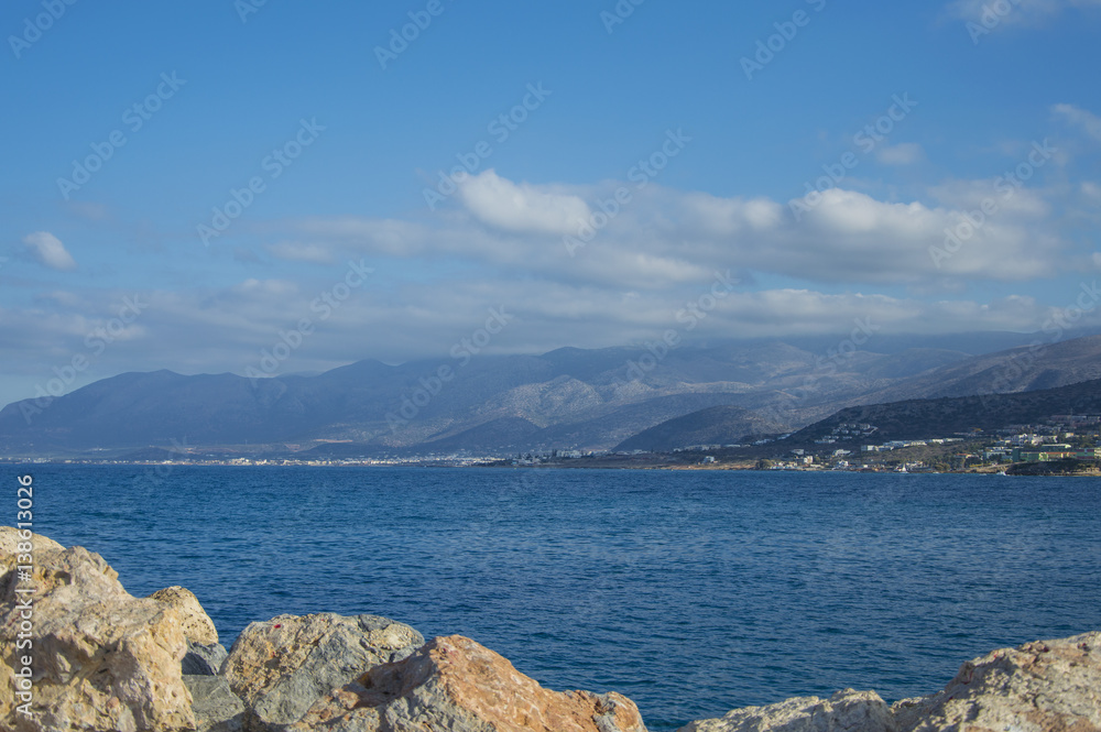 Stones in sea bay on the background of mountains, Hersonnisos Greece