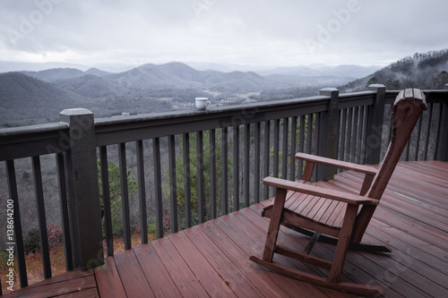 Terrace with chair, cup of coffee and mountain view