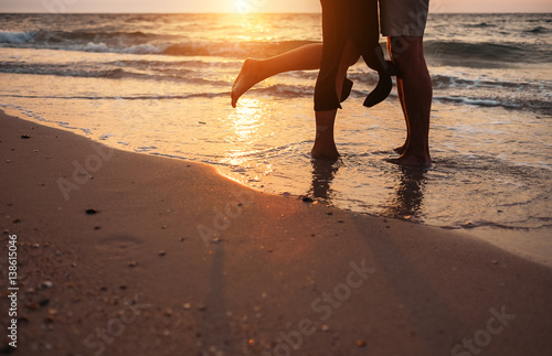 Close up image man and woman legs on surf sea line