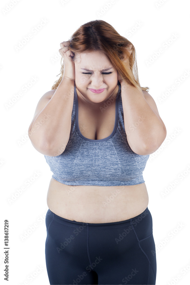 Frustrated overweight woman in studio Frustrated overweight woman in studio