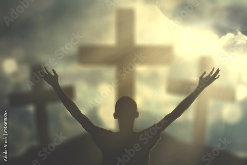 Quadro em tela Silhouette man with crucifix symbol