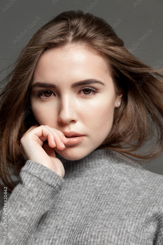 Pretty brunette female cute woman with flying hair looking at the camera Pretty brunette female cute woman with flying hair looking at the camera