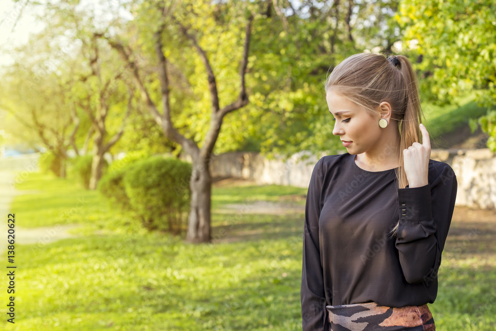 Attractive girl looks into the distance. Spring on the street Attractive girl looks into the distance. Spring on the street