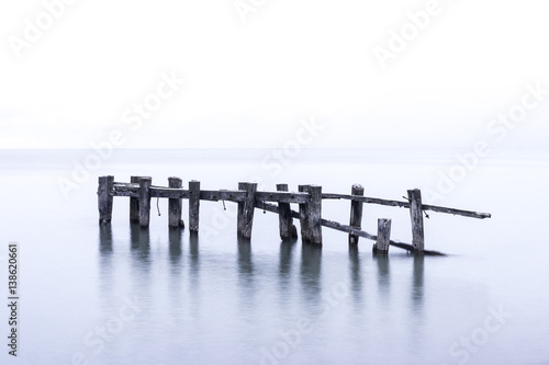 Wallpaper Mural Rustic broken pier wooden posts standing in calm blue lake waters Torontodigital.ca