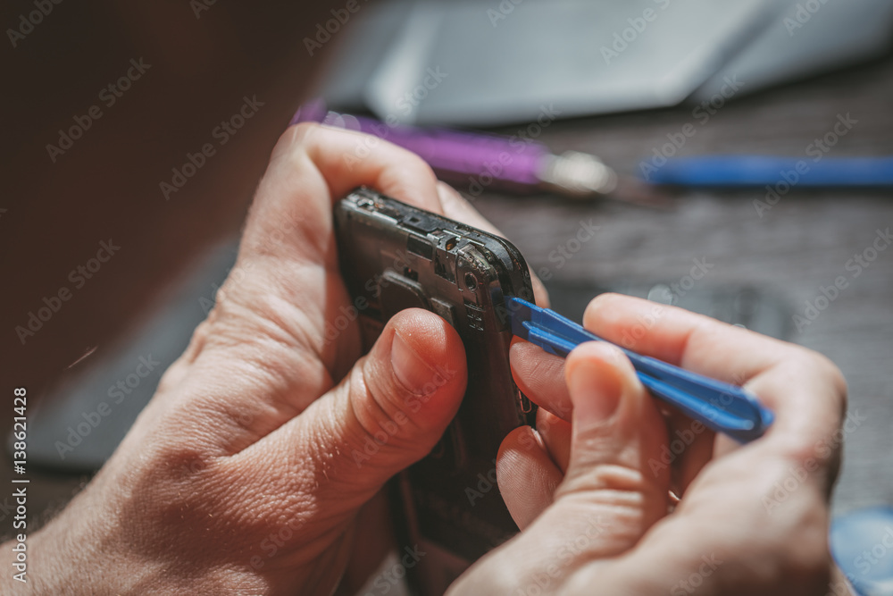 Fototapeta premium Man Repairing A Mobile phone