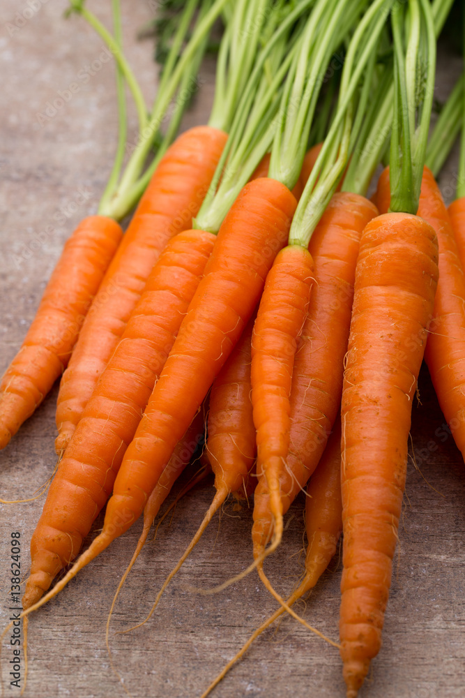 Fresh and sweet carrot on a grey wooden table. Fresh and sweet carrot on a grey wooden table.