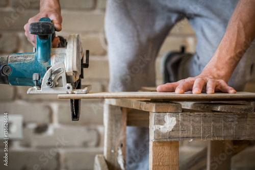 a man working with manual electric saw