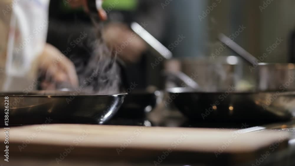 Close-up of chef hands preparing pancakes on pan in kitchen Close-up of chef hands preparing pancakes on pan in kitchen
