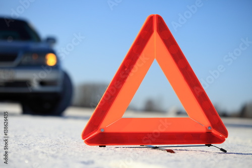 Car accident on winter road. Warning triangle.
