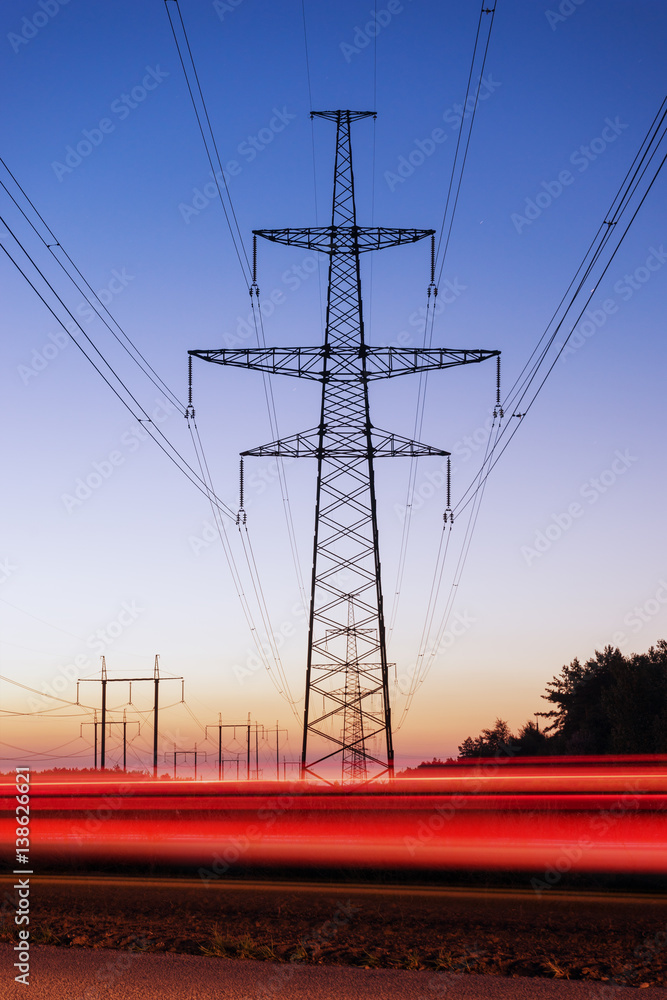 Pylon and transmission power line in sunset.