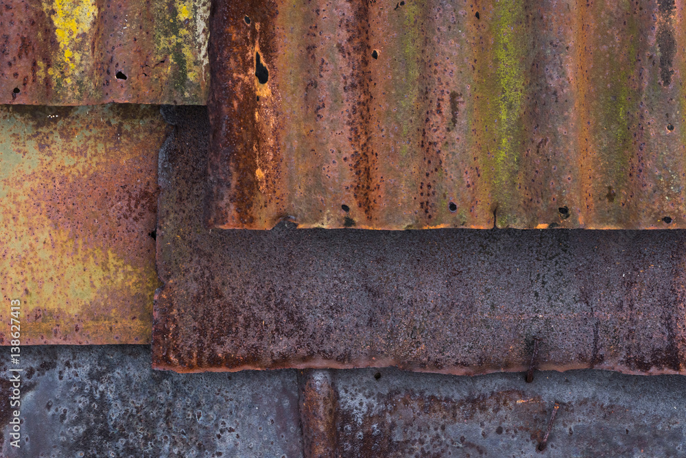 Backdrop of the barn covered with old rusty tin sheets and slate, background Backdrop of the barn covered with old rusty tin sheets and slate, background