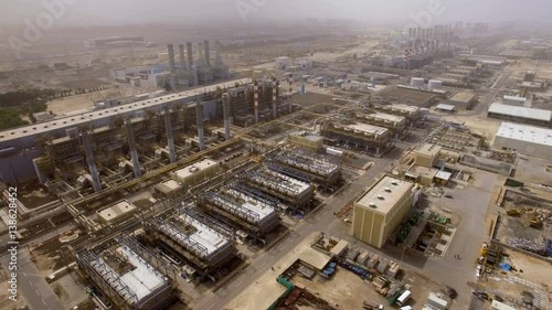 aerial view of a huge power plant with pipes, hangars and workshops in Dubai, UAE