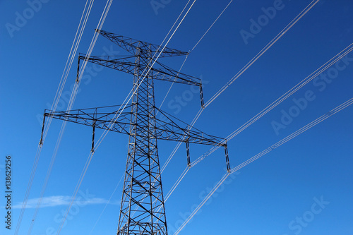 high voltage  steel pylon against blue sky