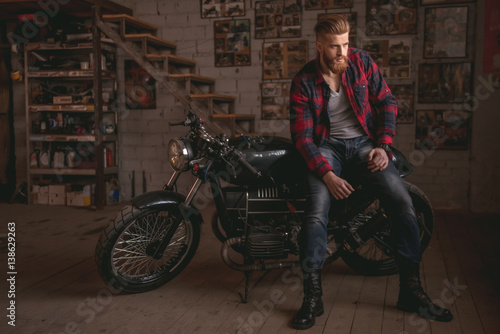 Guy in motorbike repair shop
