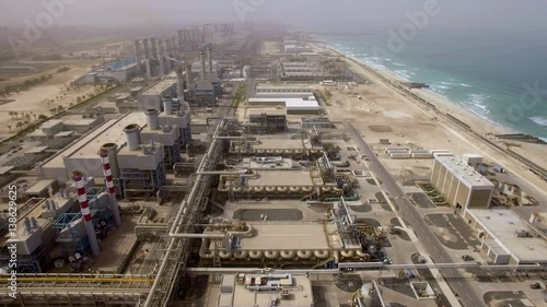 Aerial view of a huge power plant on the shore of the sea in Dubai, UAE