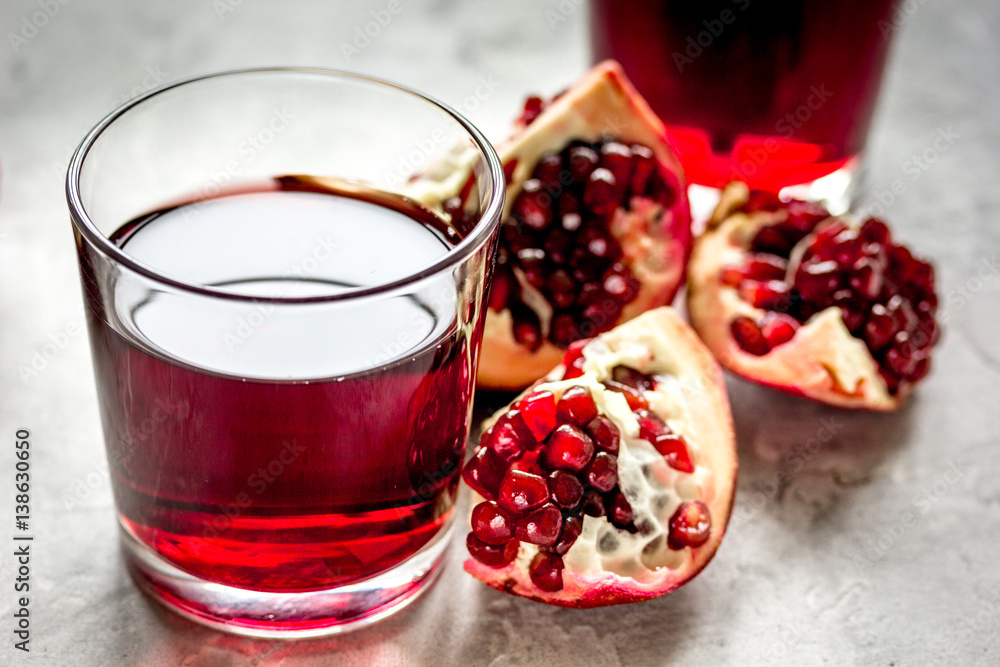 fresh pomegranate with juice in glasses on kitchen background fresh pomegranate with juice in glasses on kitchen background
