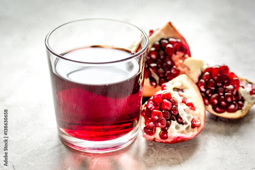 pomegranate juice with seed on stone table background pomegranate juice with seed on stone table background