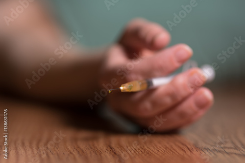 woman laying on the ground with needle in hand