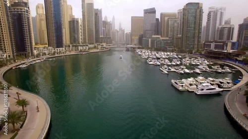 beautiful aerial view on bay with yachts and embankment among the skyscrapers in Dubai, UAE