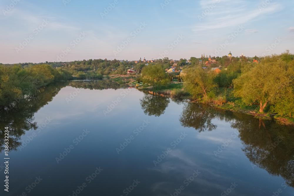 Spring evening landscape with the river and a small town on the shore.River Osetr and the city of Zaraysk in Moscow region