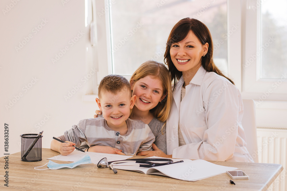 Female doctor with kids posing, looking at camera Female doctor with kids posing, looking at camera