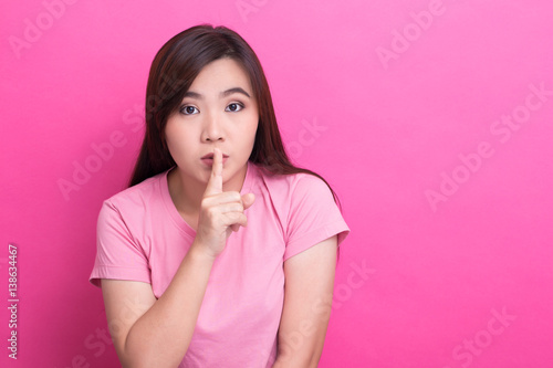 Asian woman make quiet gesture
