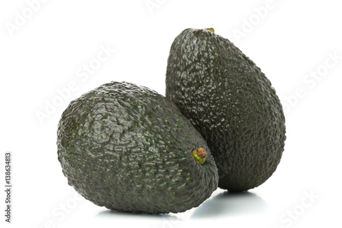 Two whole, uncut ripe avocado fruit