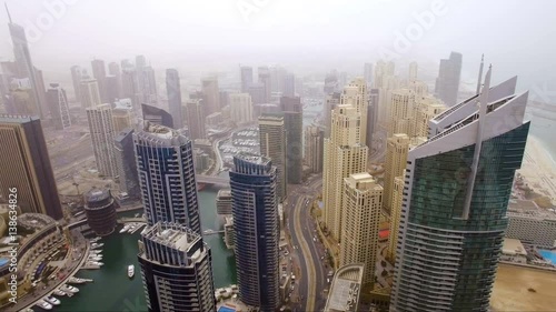 beautiful aerial view on bay with yachts and embankment among the skyscrapers in Dubai, UAE