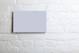 lilac blank poster in a white brick wall. Template Mock up for your content
