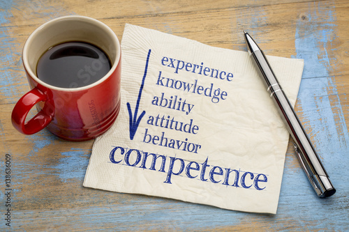 competence concept on napkin with coffee photo