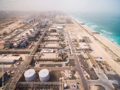 Aerial view of a huge power plant on the shore of the sea in Dubai, UAE